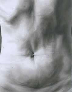 a black and white photo of a woman's stomach