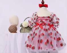 Our enchanting Strawberry Pattern Dress for children, crafted from luxurious tulle, satin, and organza, and adorned with delicate pearls. This knee-length dress is perfect for making your little one feel like a princess. The full set includes a beautifully designed dress, a matching headband, and a pair of red shoes.  This dress is ideal for various special occasions, including: - Birthday parties - Family gatherings - Weddings - Holiday celebrations - Photo shoots - School events Make every event memorable with this stunning Strawberry Pattern Dress, designed to bring joy and elegance to your child's wardrobe. Berry 1st Birthday, Baby Birthday Outfit, Berry First Birthday, Patriotic Dresses, Strawberry Baby, 1st Birthday Outfit, Smash Cake Photoshoot, Personalized Baby Girl, Elegant Baby