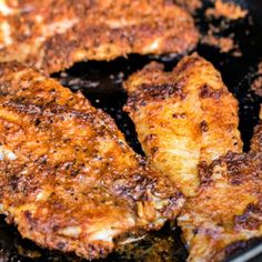 some chicken is cooking in a skillet on the stove top and it looks like they have been fried