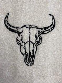 an embroidered bull skull on a white towel