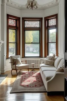 a living room filled with furniture and windows