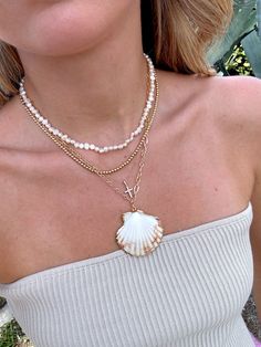 Our Shell Yeah Gold Filled Necklace is the perfect necklace for the beach lover. This necklace features 24k Gold Filled chain, real sea shell with gold plated edges, and lightweight for layering. Style this necklace with your favorite summer dress, your next beach trip with your fave bikini, or with your fave graphic tee! Please be gentle with your shell ♡ All accessories are final sale. Cheap Casual Strand Shell Necklace, Cheap Beachy Shell Necklace, Cheap Shell Necklaces For Vacation, Affordable Beachy Shell Necklace, Luxury Shell Necklaces For The Beach, Real Shell Necklace, Beach Necklace Stack, Living Mood Board, Necklace Stacks