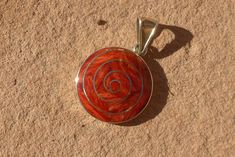 This beautiful pachamama (mother earth) pendant is made by hand by the beautiful Quechua people of the Peruvian Andes. Weight : 6.6 gr diameter : 2.6 cm height with hook : 4 cm It is handmade in 950 silver with crystacola stone by a local family of jewelry artisans. Handmade Bohemian Swirl Jewelry, Bohemian Spiral Jewelry For Healing, Bohemian Swirl Jewelry As A Gift, Bohemian Swirl Jewelry For Gifts, Red Spiral, Nature Ring, Star Ring, Chakra Stones, Ring Photos