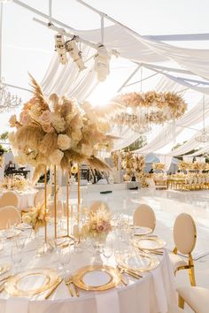 a table set up with white and gold decorations