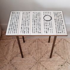 a white table with black dots on it