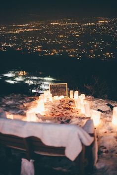 a table with candles on top of it in the snow