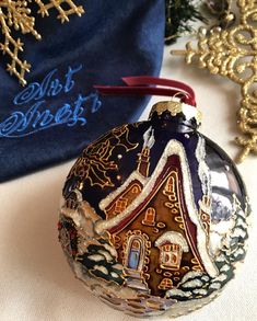 a glass ornament sitting on top of a table next to a blue bag