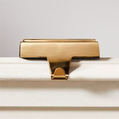 a close up of a gold handle on a white door