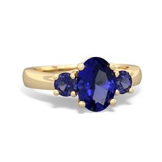 a three stone ring with blue sapphire stones