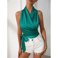 Elevate Your Look With This Teal Green Satin Crop Top, Designed To Make A Statement. The Halter Neckline And Knot Wrap Detail Create A Flattering, Slim Fit That Highlights Your Shape. Sleeveless And Made From Non-Stretch Satin, It Offers A Smooth, Polished Finish. With No Sheer Elements, This Crop Top Is Both Stylish And Versatile, Perfect For Pairing With High-Waisted Bottoms Or Layering Under A Blazer. Green Sleeveless Halter Top For Party, Green Halter Neck Tank Top For Night Out, Chic Green Blouse With Vest Detail, Elegant Summer Halter Top, Elegant Green Vest Top, Elegant Green Tank Top For Summer, Spring Party Blouse With Halter Neck, Green V-neck Tank Top For Night Out, Elegant Green Tank Top