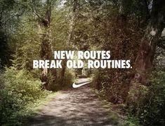 the words new routes break old routines on a dirt road surrounded by trees