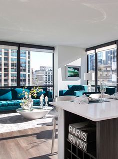 a kitchen and living room with large windows