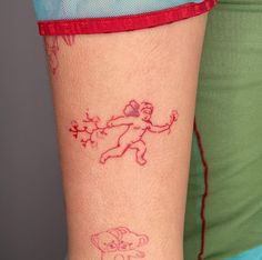 a woman with a tattoo on her arm that has an elephant drawn on the side