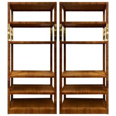 two wooden shelvings with brass handles on each side and one shelf is empty