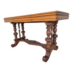 an antique wooden table with turned legs and carved wood details on the top, isolated against a white background