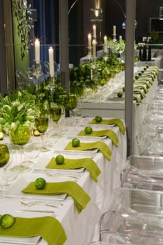 a long table is set with limes and place settings for an elegant dinner party