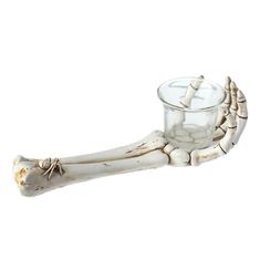 a small glass with a bone in it