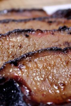 three pieces of meat sitting on top of a white plate