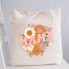 "Mama Floral Tote Bag Canvas - Perfect gift for a mom Why these aren't your average canvas bags? These canvas tote bags are roomy as they are 3\" deep Highly durable as it's made of thick 12 oz canvas Has a velcro closure in the middle to keep your contents safe Sustainable and eco-friendly. Say goodbye to plastic! 12 oz. 100% heavy cotton canvas. Product Size: 16\"W x 14\"H x 3\"D Webbed handles Handle height 10.5 \" Machine washable, eco-friendly, durable, recyclable. Totes are perfect for carrying books, clothing, tradeshow goodies and more Bulk Discounts available. RETURNS/EXCHANGES: We do not accept returns as these are made to order just for you, BUT If for any reason you are not completely satisfied with your order, just send us a message and we'll sort out the issue as soon as poss Pink Shoulder Bag For Mother's Day, Pink Shoulder Bag For Everyday And Mother's Day, Mother's Day Large Capacity Tote Shoulder Bag, Pink Everyday Bag For Mother's Day, Pink Tote Bag For Mother's Day, Mother's Day Canvas Tote Bag, Mother's Day Shopping Tote Canvas Bag, Mother's Day Gift Bag In Beige, Canvas Tote Bag For Mother's Day