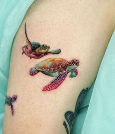 two sea turtle tattoos on the arm