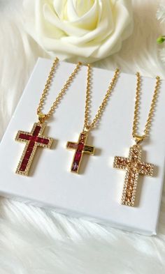 Gorgeous sparkling holy cross pendants on timeless stainless steel gold chains. Choose your style below: From left to right: Style 1 - Raspberry 33mm pendant length Gold-Plating over Copper Style 2 - Multi 25mm pendant length Gold-Plating over Copper Style 3 - Beige 33mm pendant length Gold-Plating over Copper Makes a wonderful gift 🎁 Catholic Cross Necklace, Schmuck Gold, Catholic Cross, Necklace Christian, Cross Gift, Copper Style, Holy Cross, Confirmation Gifts, Christian Cross