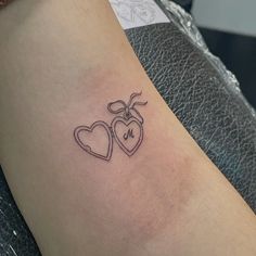 a couple of hearts tattoo on the arm