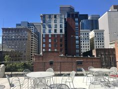 tables and chairs are set up on the roof of an apartment building in new york city