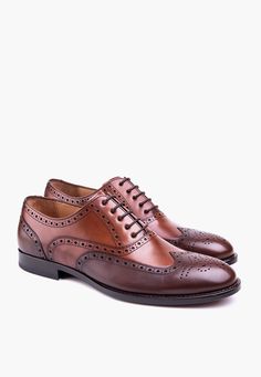 A traditional oxford brogue elevated with a modern look. Claremont Oxford provides a tasty combination of classic wingtip oxford with modern color choices. Leather Upper Leather Lining Full Leather Insole Leather Outsole Lightly Cushioned on Heel Luxury Cognac Oxfords For Semi-formal, Luxury Brown Slip-on Oxfords, Semi-formal Cognac Oxfords With Brogue Detailing, Luxury Brown Semi-formal Oxfords, Brown Slip-on Goodyear Welted Oxfords, Shoes Names, Themed Shirts, Oxford Brogues, Wingtip Oxford