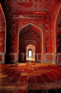 the inside of an ornate building with red and white walls