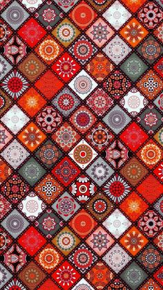 an orange and red patchwork pattern with many different designs on it's surface