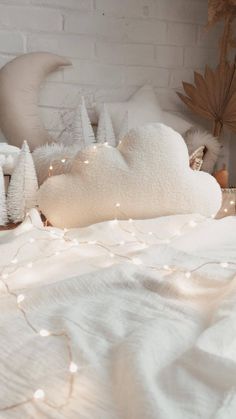 a white bed topped with pillows and blankets