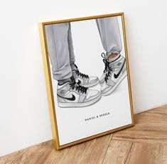 an image of a pair of shoes on the floor in front of a framed photograph