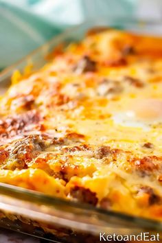 a cheesy casserole dish with meat and cheese on top, ready to be eaten