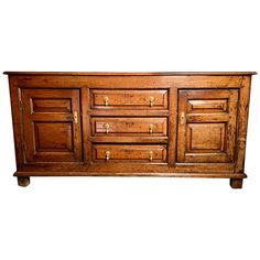 an old wooden sideboard with many drawers