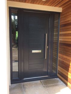 a black front door on a wooden house