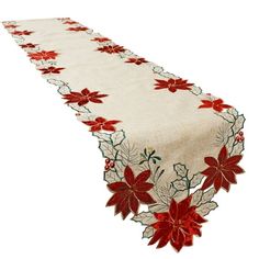 a table runner with poinsettis and leaves on it