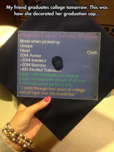 a person holding up a graduation cap that has information about the graduate's degree