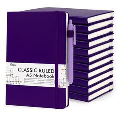 a stack of purple notebooks sitting on top of each other