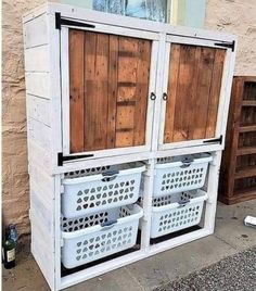 an outdoor storage unit made out of pallets and wood planks with baskets on the bottom