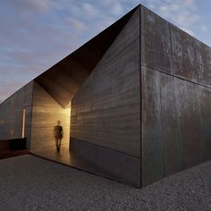 a person standing in front of a building with an open door on the outside and inside