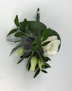 a bouquet of white flowers and green leaves