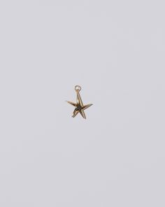 Verve Five Point Star Charm on light color background. Sterling Silver Jewelry With Yellow Gold Star Charm, Elegant Star-shaped Jewelry With Starfish Charm, Yellow Gold Round Star Charm Jewelry, Elegant Jewelry With Starfish Charm, 14k Gold Star Charm Jewelry, Yellow Gold Round Jewelry With Star Charm, Yellow Gold Jewelry With Star Charm, Yellow Gold Star-shaped Jewelry With Charms, Star-shaped Hallmarked Formal Jewelry