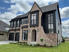 a brick house with black shutters on the front and side windows is shown in this photo