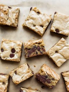 chocolate chip cookie bars cut into squares on a sheet of parchment paper, ready to be eaten