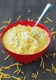 a red bowl filled with macaroni and cheese