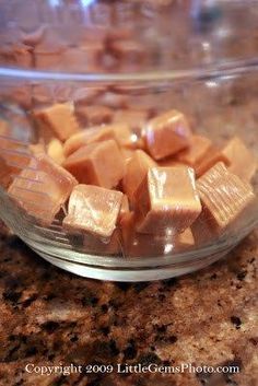 a glass bowl filled with pieces of chocolate