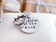 Daughter of the King is hand stamped on the front of this beautiful, sterling silver pendant. You can choose ''bat melech'' OR your very own personalization is on the back. You have the choice of front and back or front only. She knows who she is... more importantly... she knows Who's she is... She is a daughter of the King. FEATURES 1 inch sterling silver hand stamped disk Hammered texture Crown charm - base metal, zinc alloy metal which is lead and nickel free. Choice of chain CHAINS 1. Stainl Inspirational Adjustable Necklace For Personalized Gift, Meaningful Adjustable Necklace For Personalized Gift, Inspirational Adjustable Necklace For Mom, Inspirational Hallmark Jewelry As A Gift For Mom, Inspirational Hallmarked Jewelry For Mom, Meaningful Adjustable Necklace As Gift, Inspirational Stamped Jewelry For Best Friend Gift, Inspirational Hand Stamped Jewelry For Best Friend, Adjustable Engraved Necklace For Mother's Day