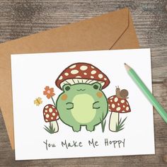 a card with an image of a green frog and mushrooms on it that says, you make me happy