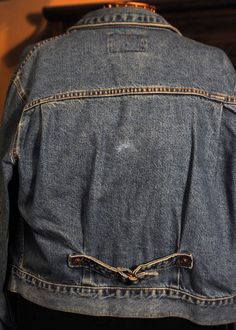 "This is a reproduction made by Levi of a Levi's Type 2 woman's Denim Jean Jacket. Pleated front. I has the buttons on the woman's side. It is in Excellent Vintage condition. The only thing I see is a small discoloration on the back. Western Styled Ranch wear.and made in the USA. The photographs that should be considered part of the description. No bad smells or damage. 2 top pockets and a Cinch Buckle Back with Gussets. It is a Medium but these jackets ran large so you should have a close look Denim Jacket With Pockets For Rodeo, Dark Wash Denim Jacket With Pockets For Rodeo, Vintage Medium Wash Denim Jacket For Rodeo, Mechanic Coveralls, Jacket Levis, Western Suits, Ranch Wear, Car Coat, Vintage Denim Jacket