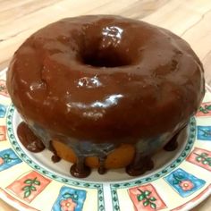 a chocolate frosted donut sitting on top of a plate